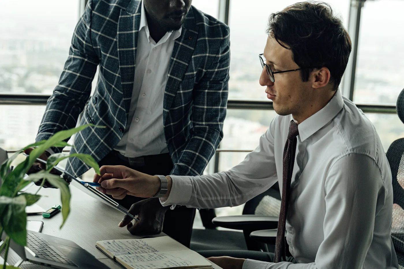 Two colleagues reviewing a workplace mental health strategy at a desk