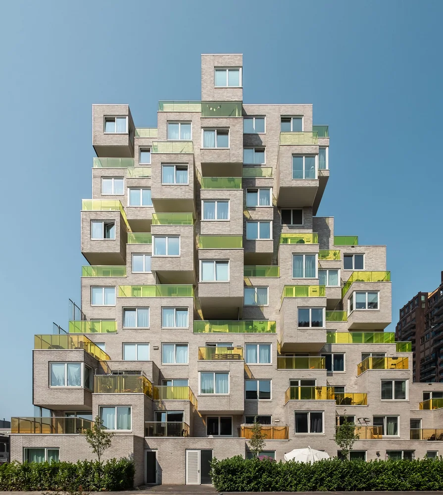 A blocky, stair-stepped apartment building that looks different from every angle